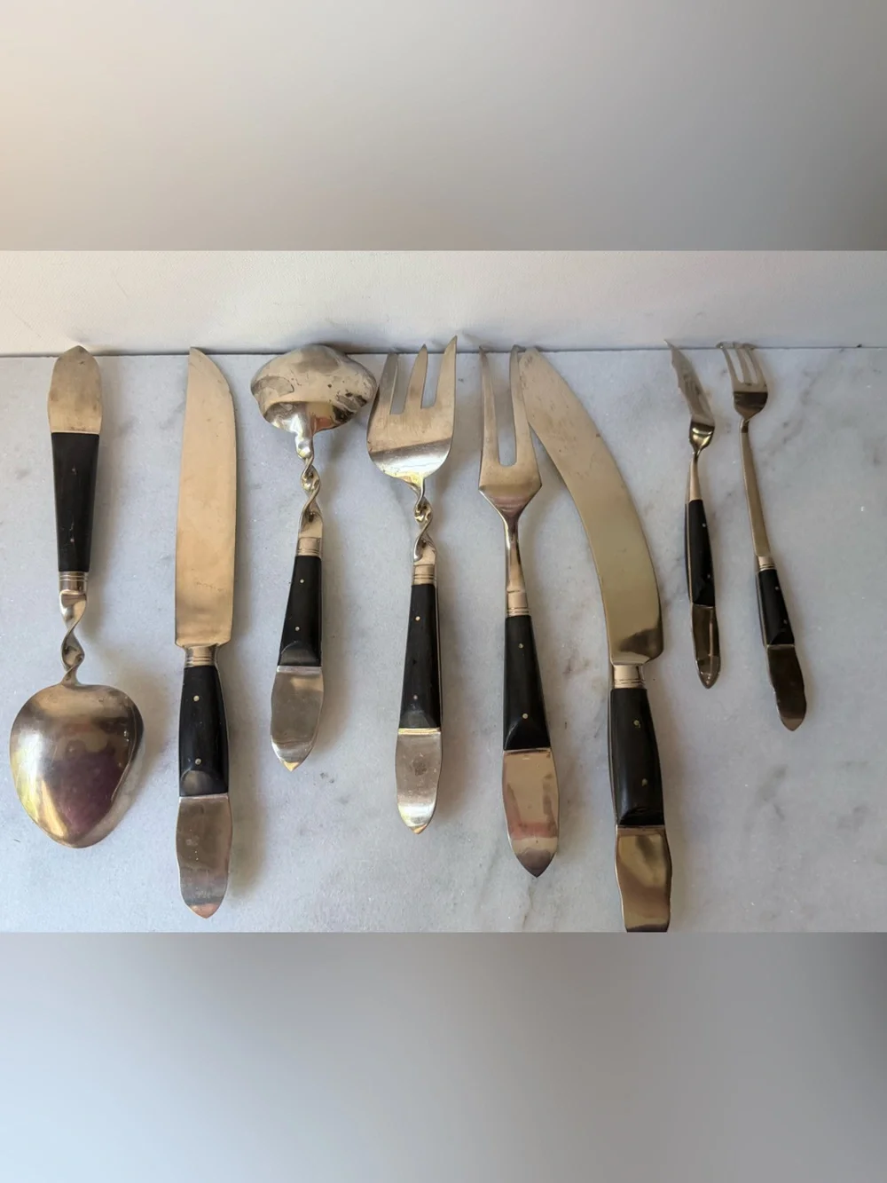 set consists of vintage Thai brass or bronze utensils with dark wooden handles.